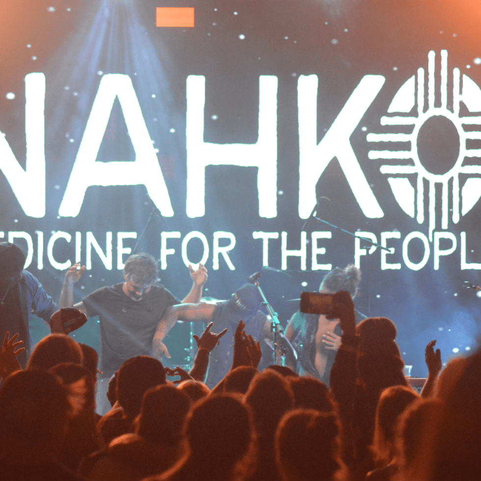 Nahko Bear and Band on Stage, Holding Hands and Taking a Bow. End of Performance.